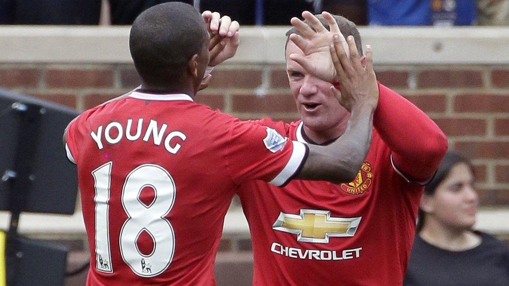 Ashley Young celebrates scoring with Wayne Rooney