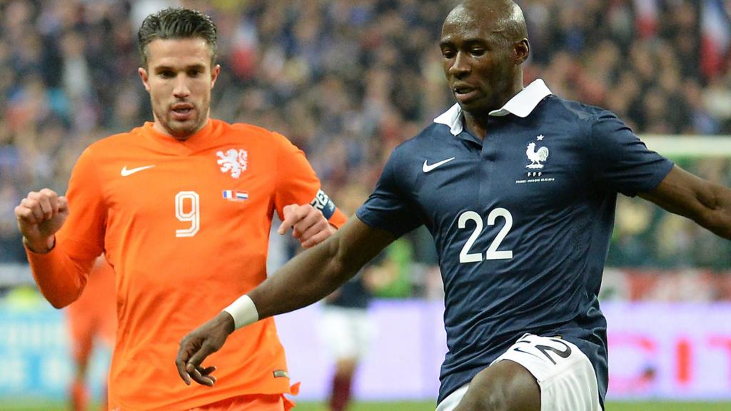 Manchester City signing Eliaquim Mangala fends off Manchester United's Robin van Persie during a match between France and Holland