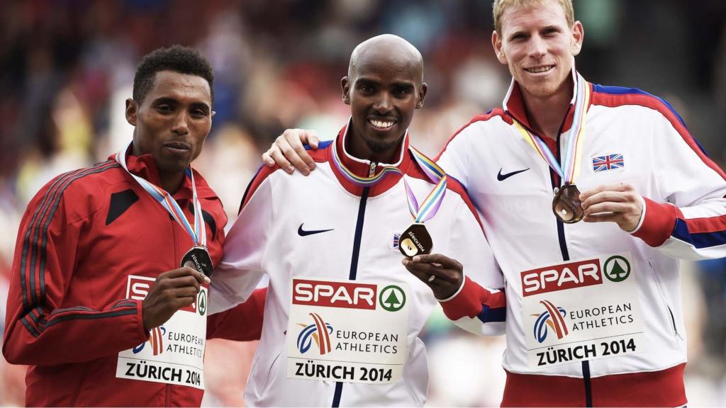 5,000m medallists pose on the podium