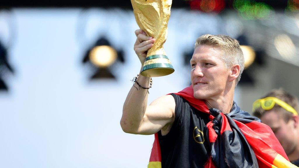 Bastian Schweinsteiger holds aloft the 2014 World Cup