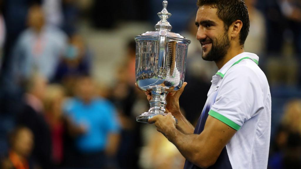 Marin Cilic of Croatia celebrates with the trophy after defeating Kei Nishikori of Japan to win the US Open men's singles final