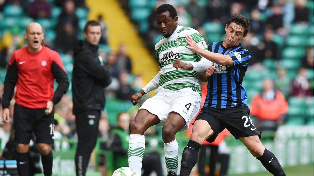 Celtic's Efe Ambrose retains possession under pressure from Hamilton's Danny Redmond