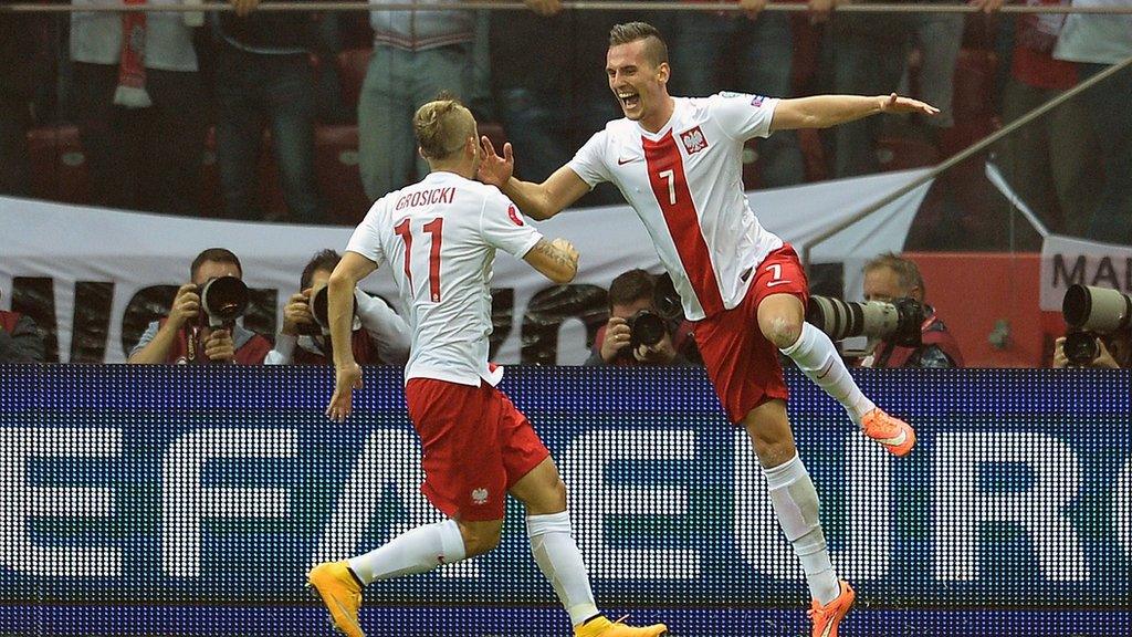 Poland's forward Arkadiusz Milik celebrates scoring against Germany with team-mate Kamil Grosicki