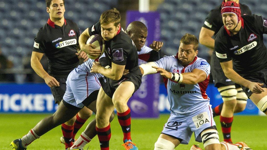 Tom Heathcote tries to escape the clutches of the Lyon players