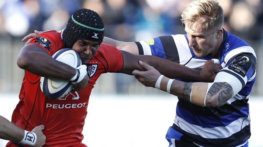 Toulouse captain Thierry Dusautoir tries to hand off Bath's Dom Day