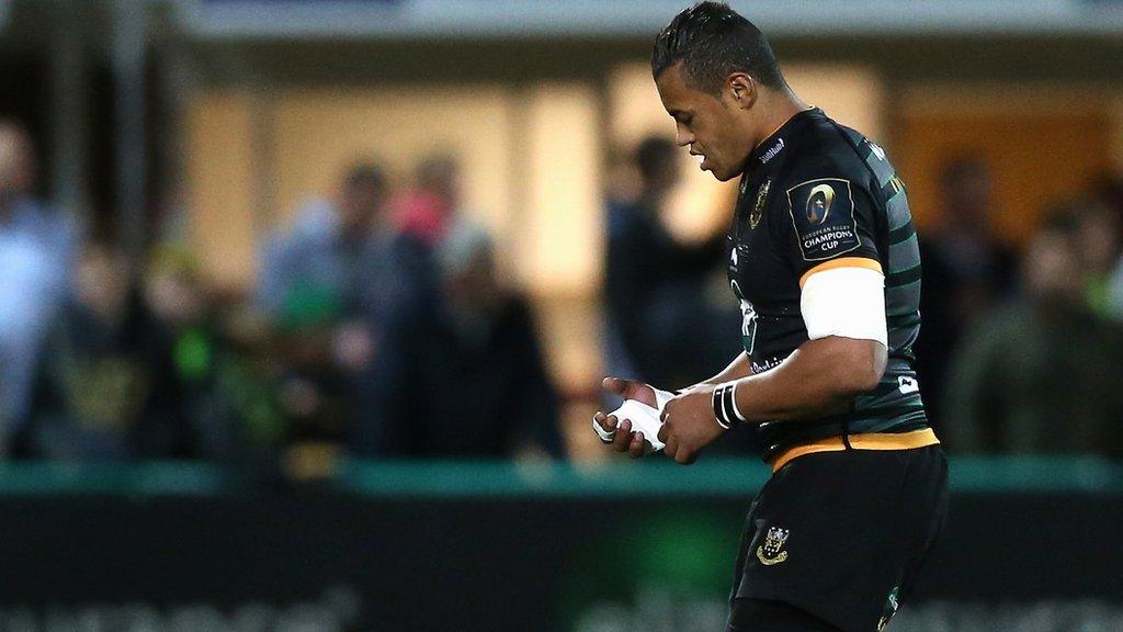 Luther Burrell holds his injured hand