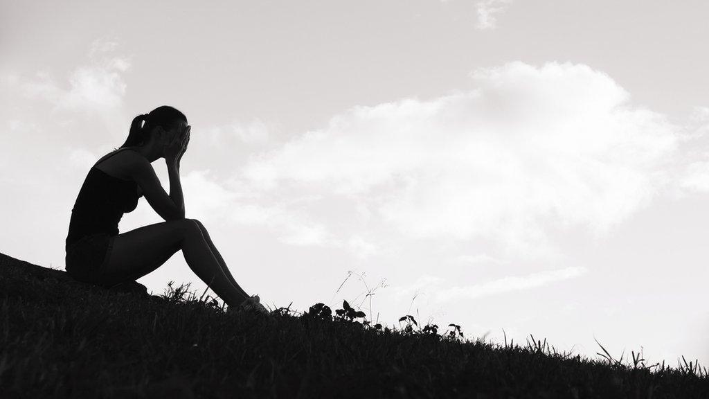 Unhappy teenage girl in silhouette