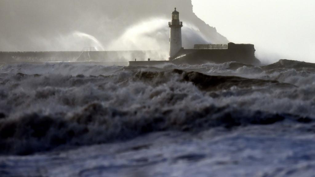 Waves crash over Whitehaven lighthouse