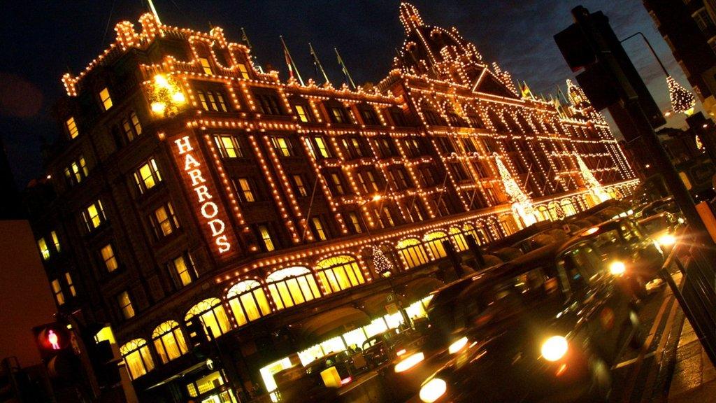 Rush hour traffic drives past Harrods department store dressed for the holidays December 20, 2001 in Knightsbridge in London. The store is traditionally covered in lights for the Christmas season