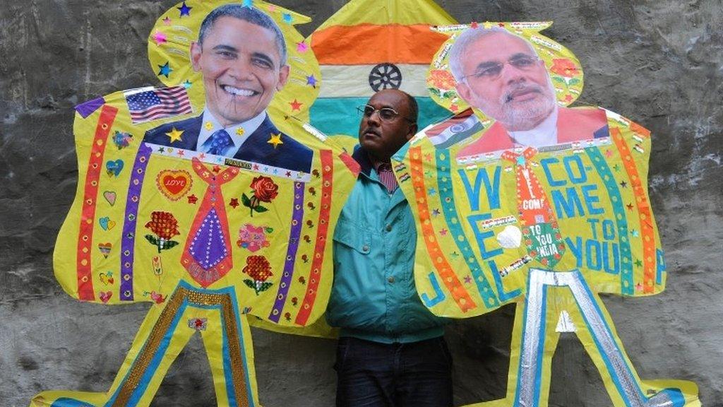 An Indian kitemaker poses with kites with images of US President Barack Obama and Indian PM Narendra Modi (in Amritsar on January 21, 2015.