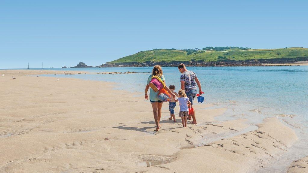 Family working along a beach