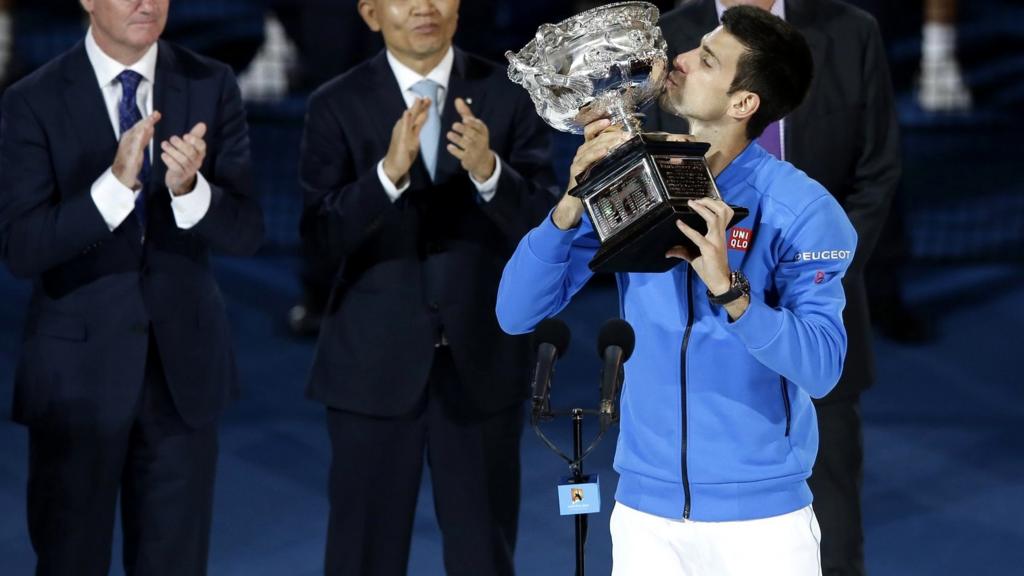 Novak Djokovic celebrates with the trophy