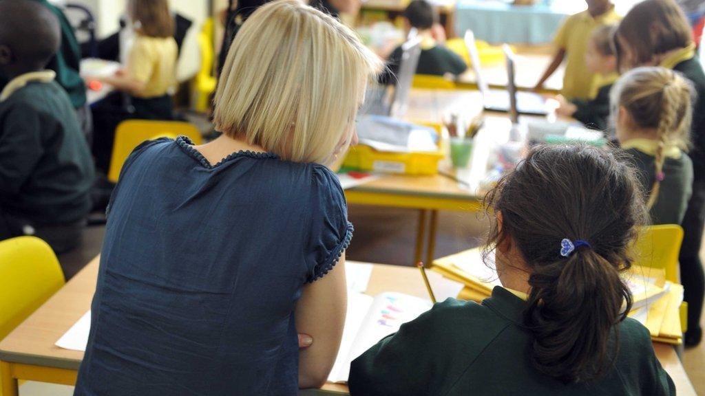 A female teacher helps a young girl at Tolworth Infant School, a primary school for boys and girls aged 3 to 7.