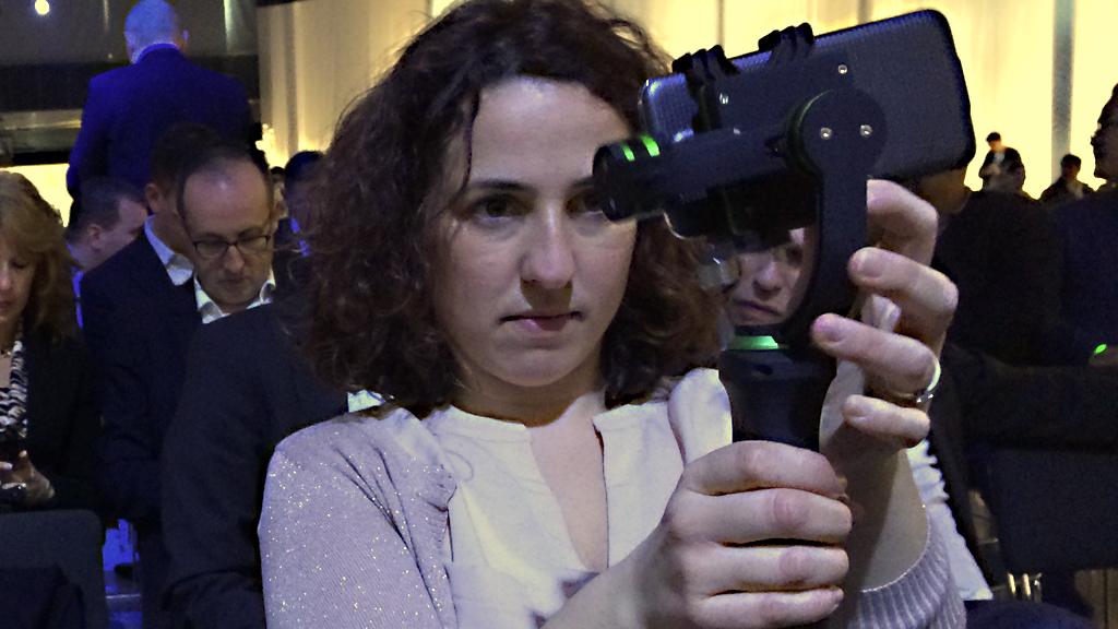 A member of the Click team filming on a mobile phone