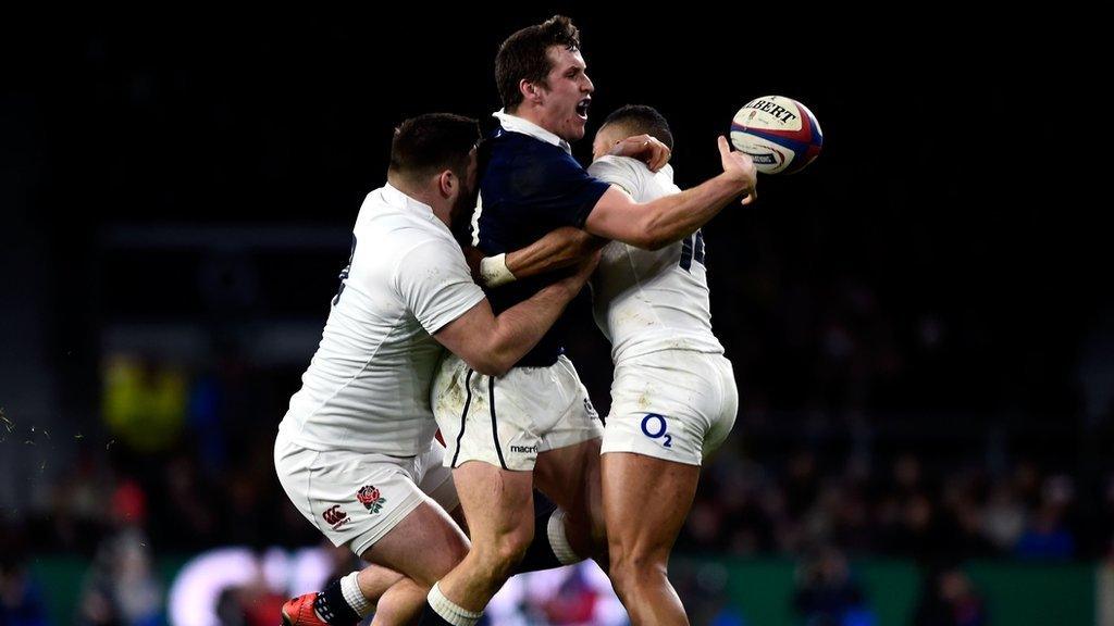 Mark Bennett is tackled by England's Kieran Brookes and Anthony Watson