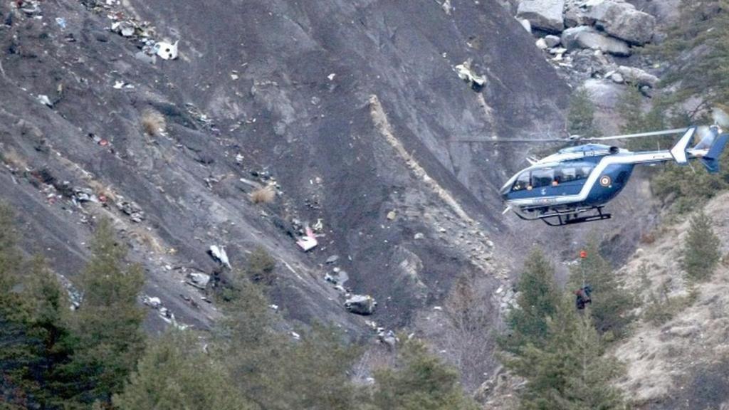 A rescue helicopter over the crash site in the French Alps