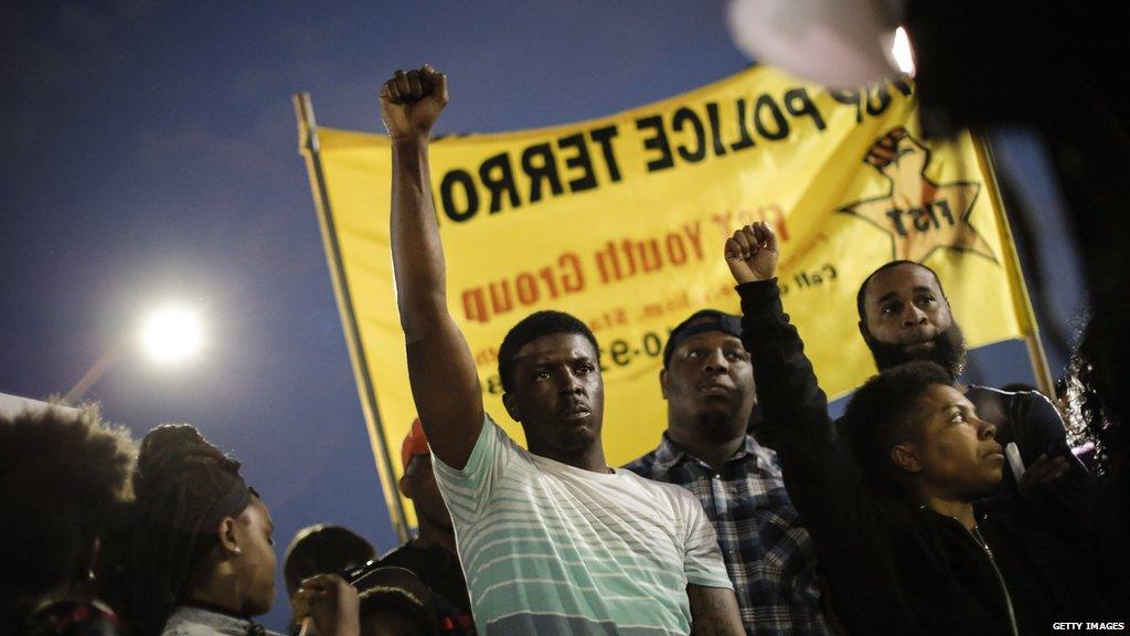 Protesters hold up their fists at a demonstration on Tuesday