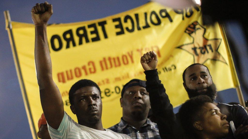 Protesters hold up their fists at a demonstration on Tuesday