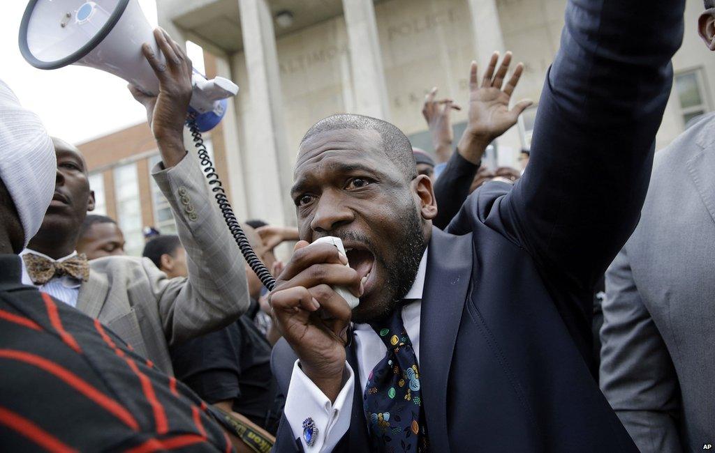 Pastor Jamal Bryant yells into a loud speaker