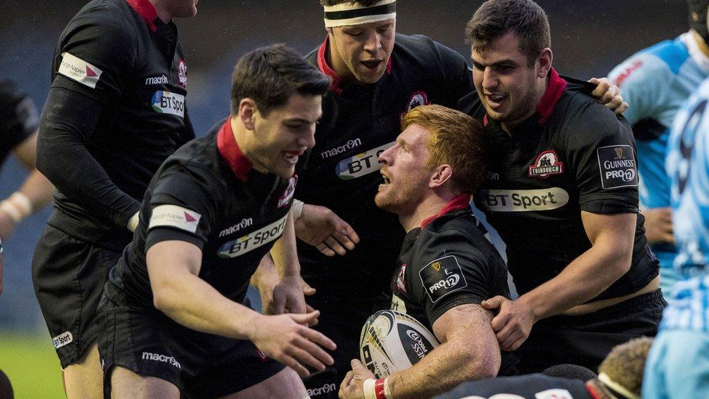 Edinburgh players surround Roddy Grant after he scored a try