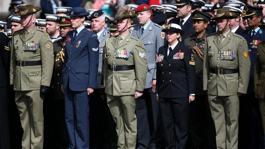 Members of the military stand during a ceremony at the Cenotaph