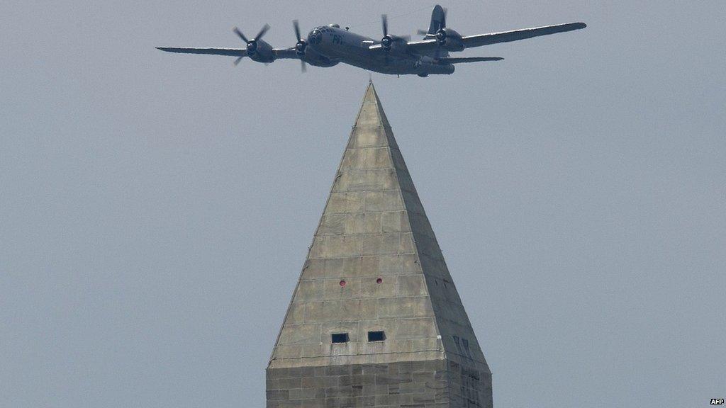 A Boeing B-29 Superfortress flies over the Washington Monument