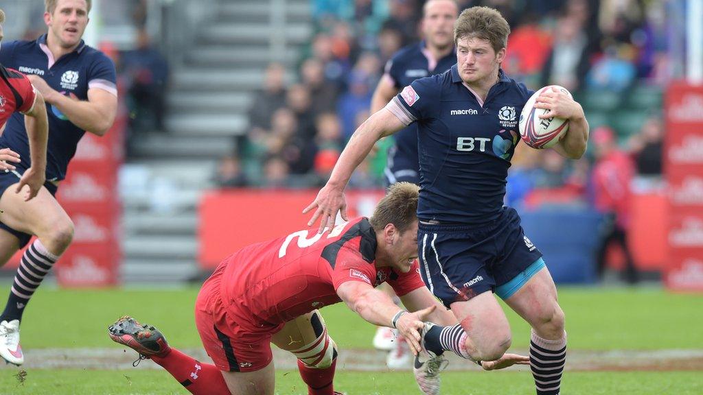 Scotland's James Johnstone is tackled by Patrick Parfrey of Canada