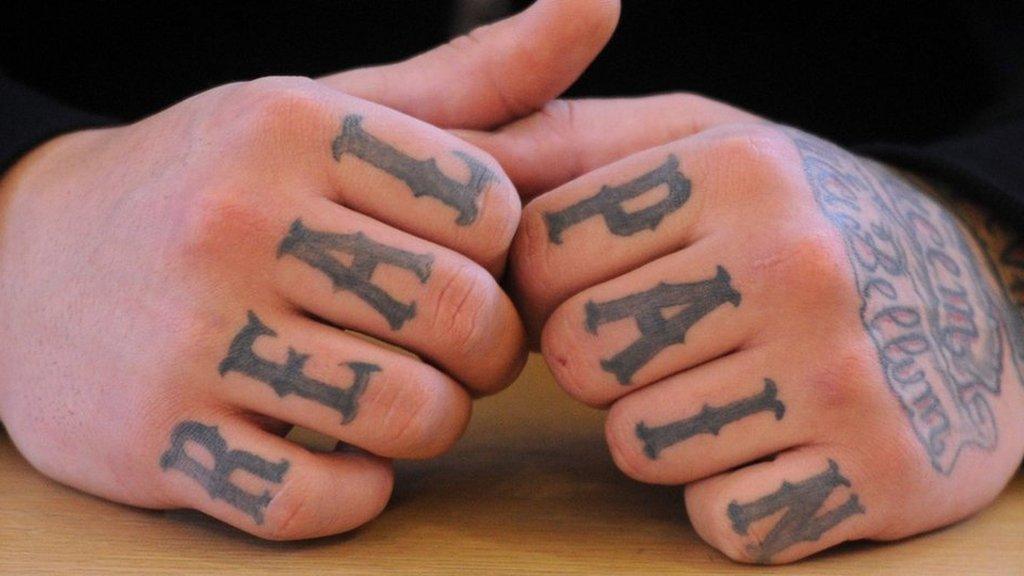 his picture taken on January 7, 2013 shows tattooed hands of a defendant rocker at a court in Pforzheim, western Germany.