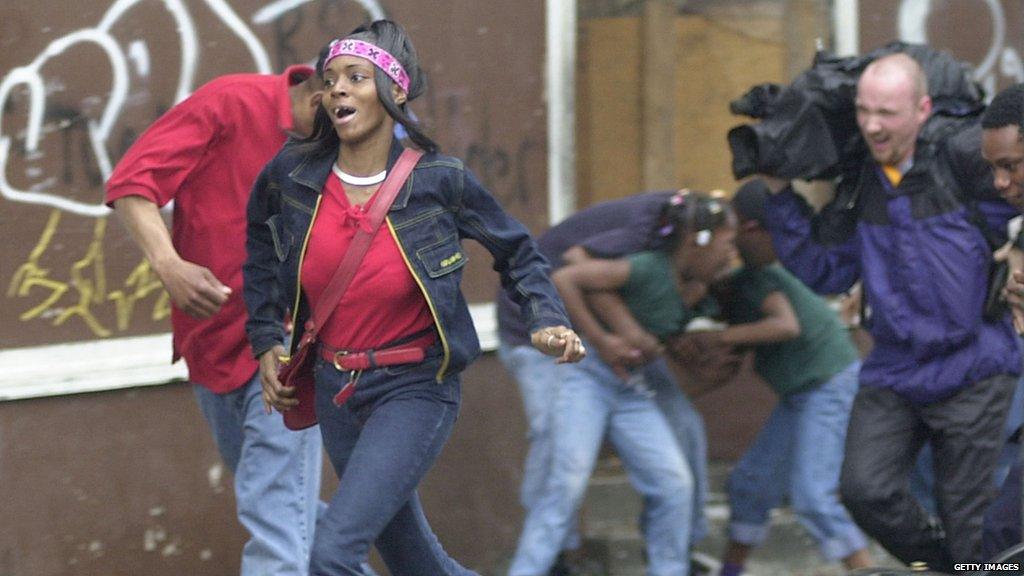 Cincinnati residents run from Cincinnati Police Officers who are shooting non-lethal ammunition at protesters in the Over The Rhine area in Downtown Cincinnati