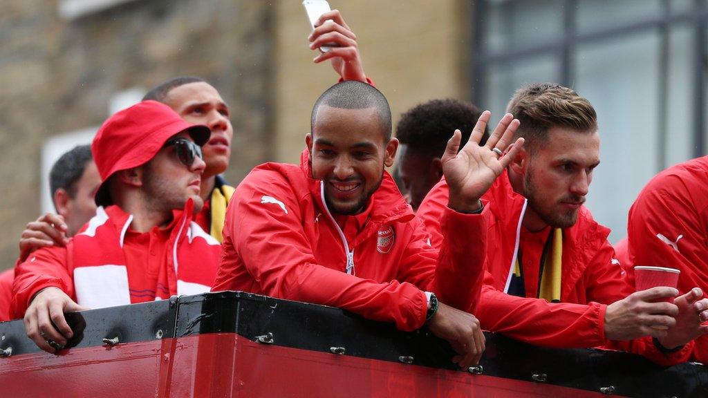 Jack Wilshere, Theo Walcott and Aaron Ramsey celebrate winning the FA Cup during the parade