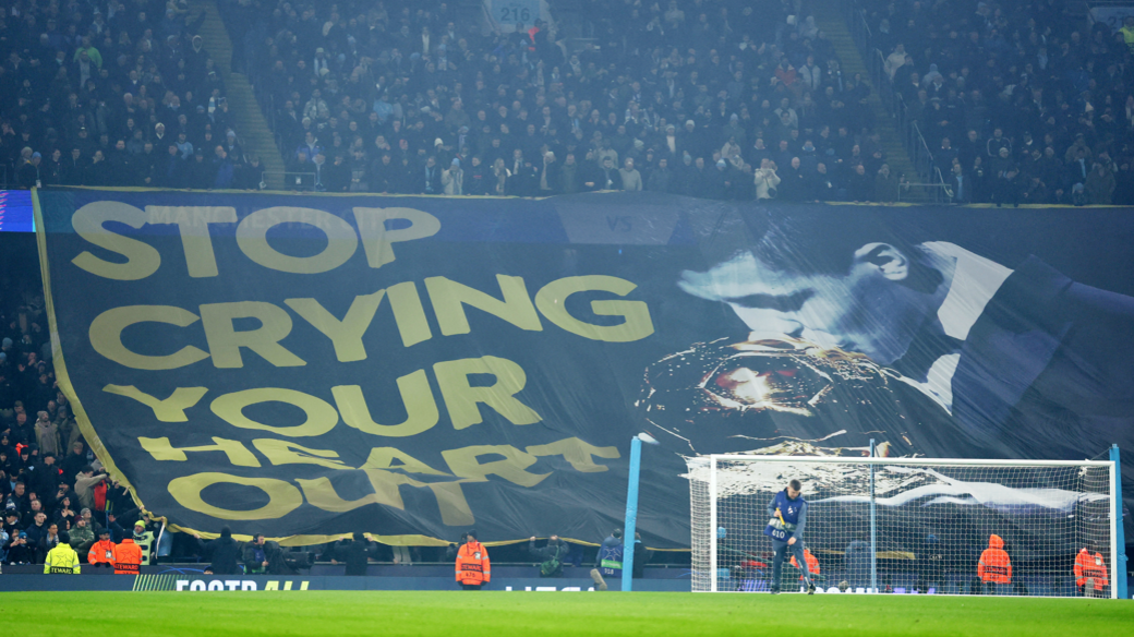 Manchester City fans display a Rodri banner inside the stadium before the first leg