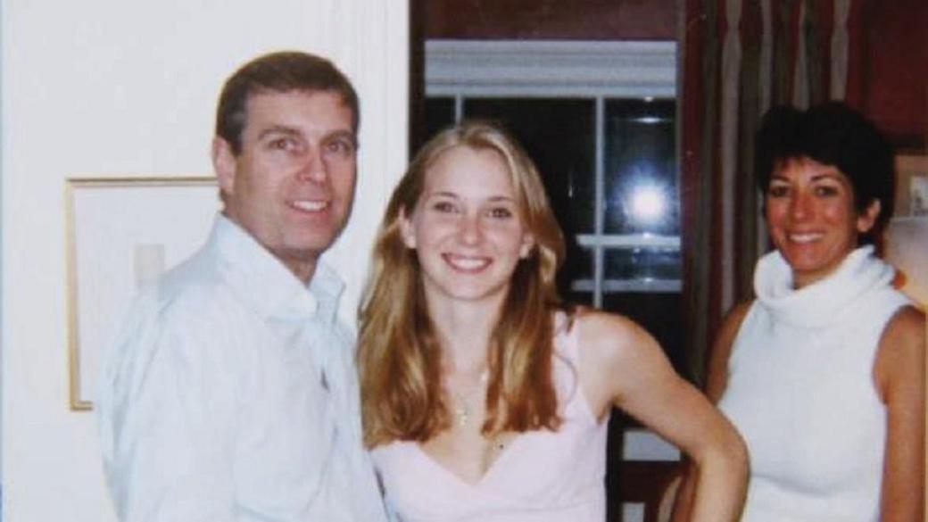 An old photograph of Prince Andrew - wearing a white shirt unbuttoned at the collar - smiling with his hand on the waist of Virginia Giuffre, a young woman with long blonde hair, while Ghislaine Maxwell stands a slightly to the side.