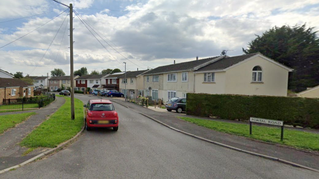 A wide shot of the entrance to Portal Road in Swindon with houses either side