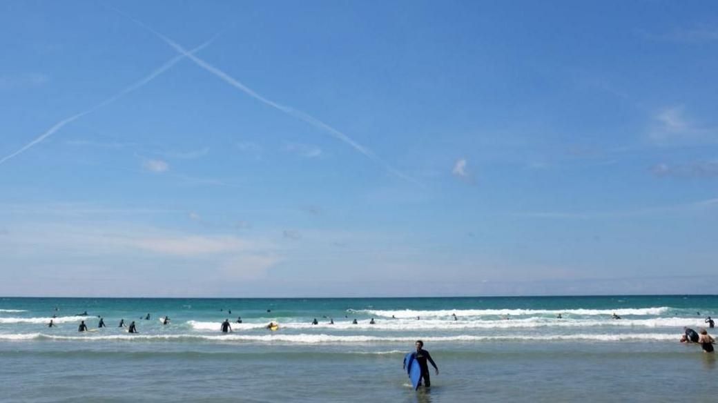 People surfing at Watergate Bay