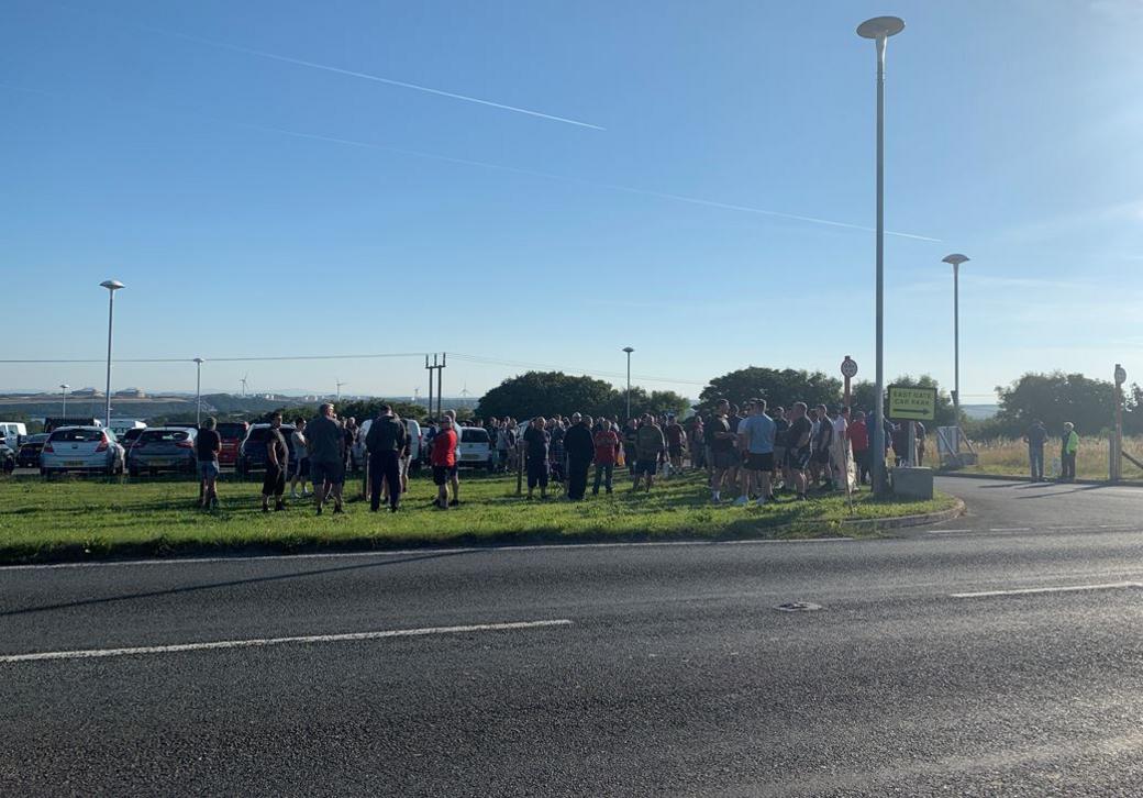 Workers outside refinery