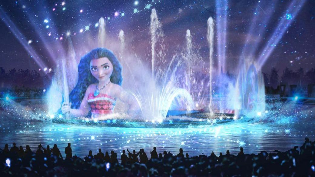 An artist impression shows drones above water at Disney Adventure World park in Paris. An image of Moana is projected onto fountains as a crowd observes the spectacle.