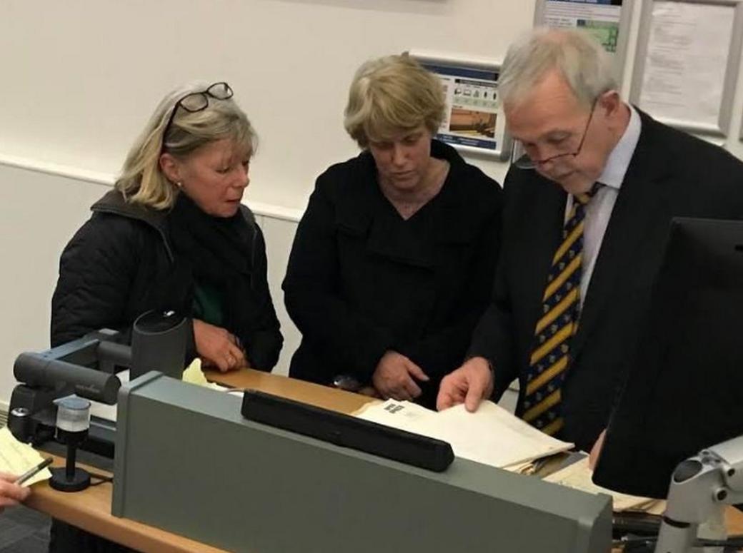 Gilly Kenny and Jenny Meade hand documents to Prof Challacombe