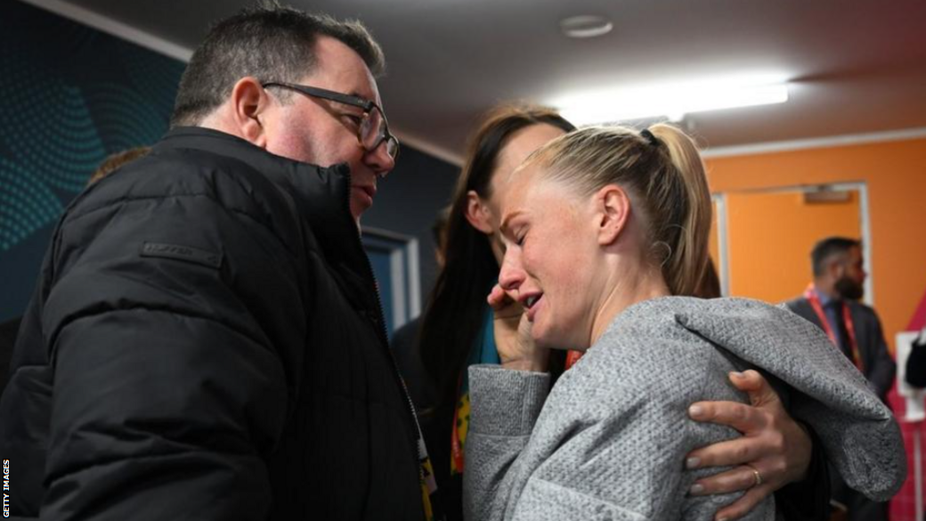 Finance minister Grant Robertson and former Prime Minister Jacinda Ardern congratulate CJ Bott after New Zealand's win over Norway