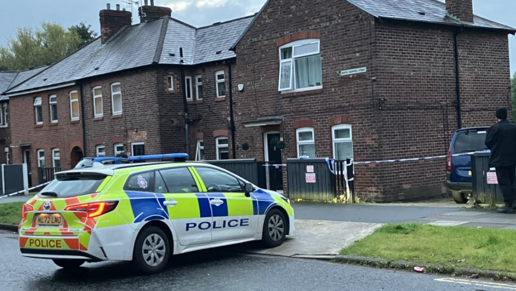 A police car outside the taped-off house where the woman and girl's bodies were found on Monday.