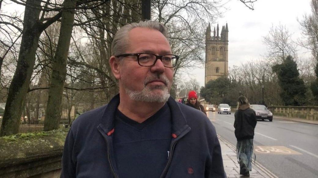 Will Studholme standing on a bridge in Oxford