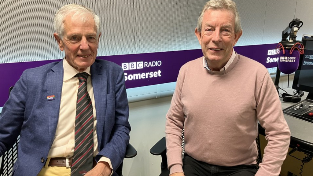 Colin Drummond and Clinton Rogers sitting in the BBC Somerset studio, smiling to camera