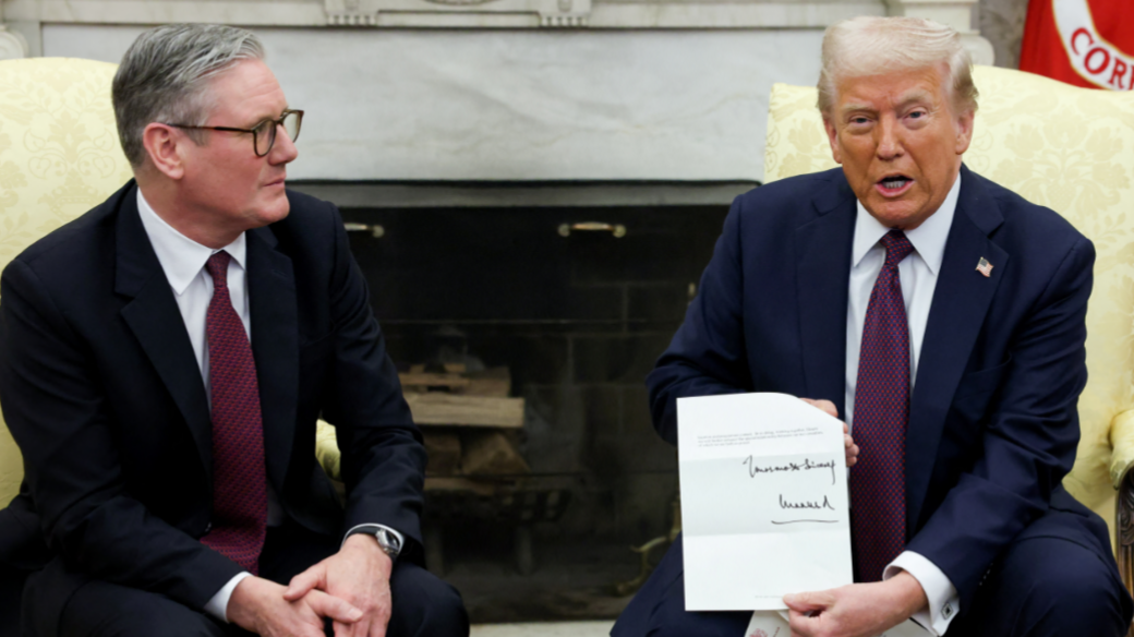 Prime Minister Keir Starmer looks on as Donald Trump holds up a letter from King Charles