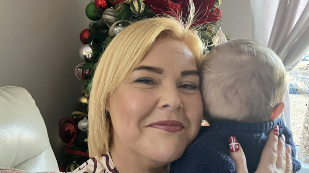 woman holding a baby at christmas time