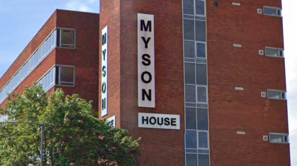 A red brick built multi-storey office block with the words Myson House on two sides