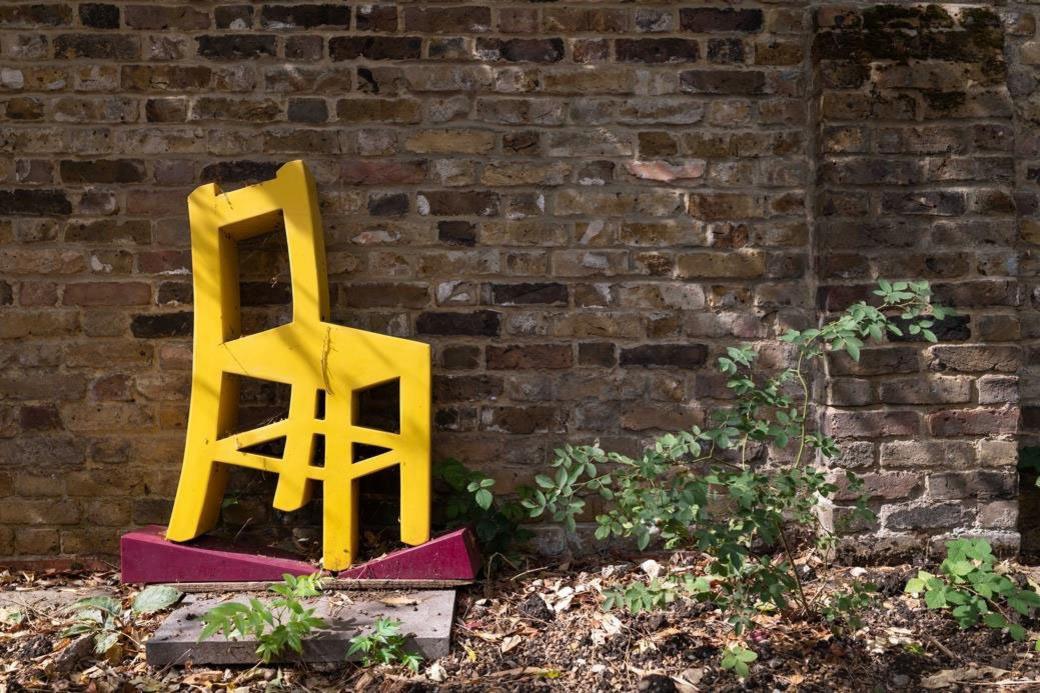 A wooden sculpture of a chair