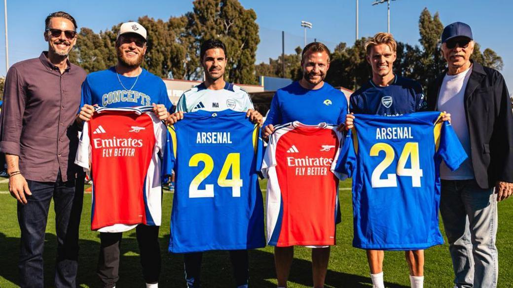 Josh Kroenke at a Los Angeles Rams youth football clinic with Rams wide receiver Cooper Kupp, Arsenal manager Mikel Arteta, Rams head coach Sean McVay, Arsenal midfielder Martin Odegaard and Stan Kroenke in July 2024