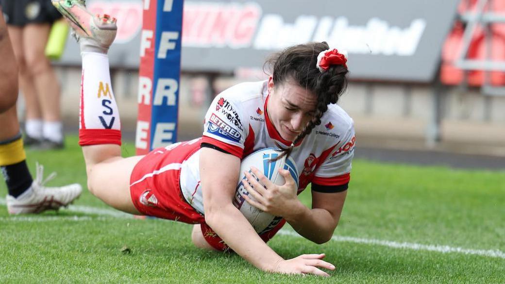 St Helens winger Leah Burke crashes over the try line.