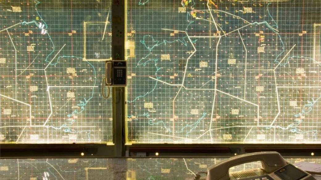 Illuminated glass map on a glass screen.