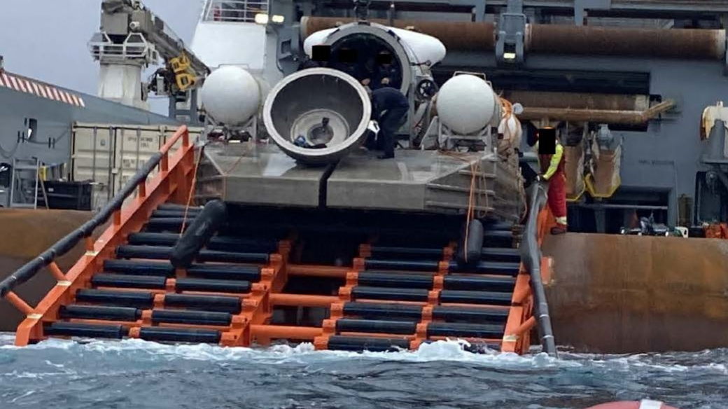 The Titan submersible is seen after being lifted out of the sea - with its dome component loose