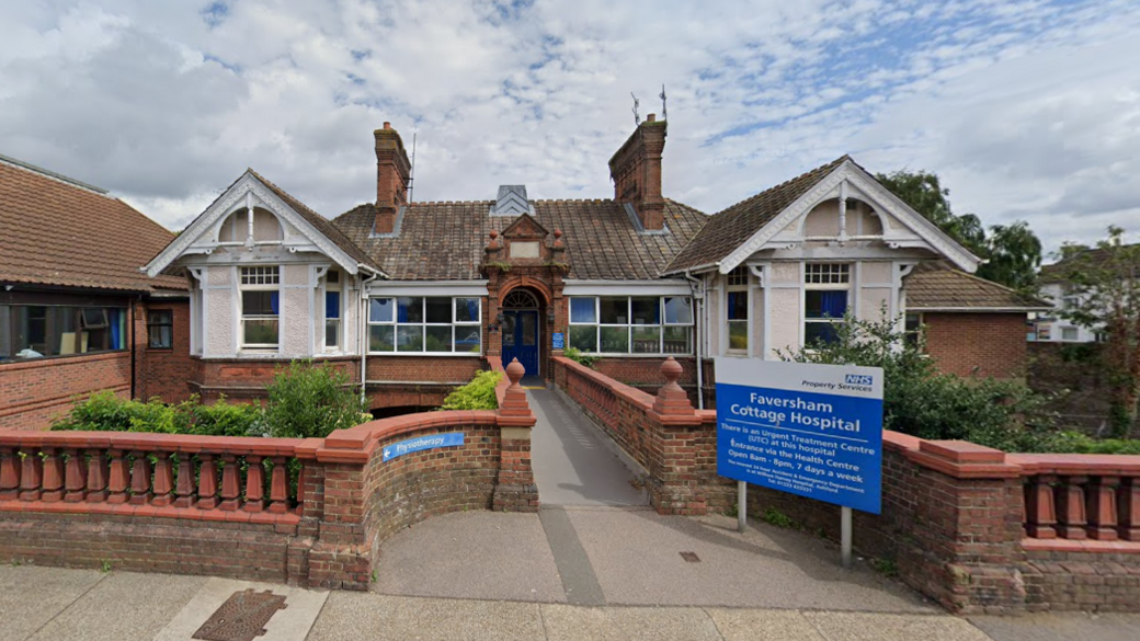 A single-storey building. There is a blue sign out the front which says "Faversham Cottage Hospital".
